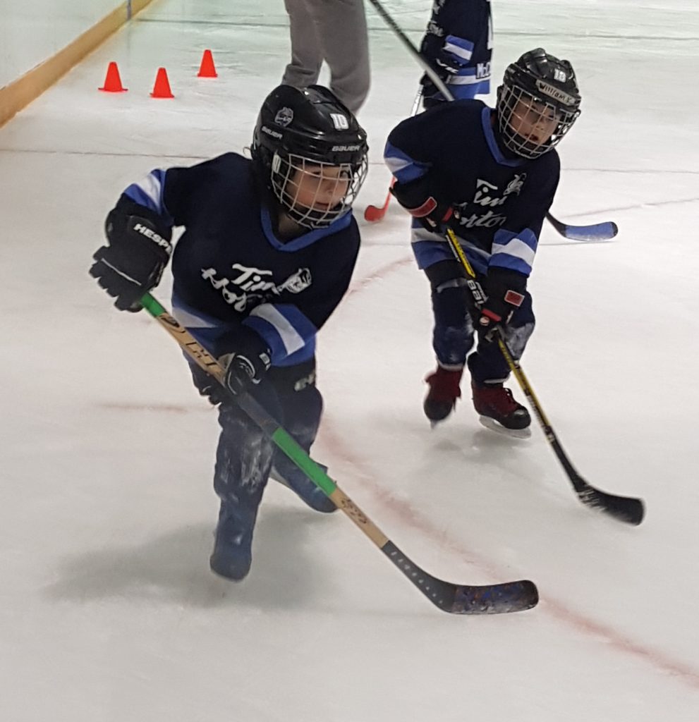 two young hockey players at practice